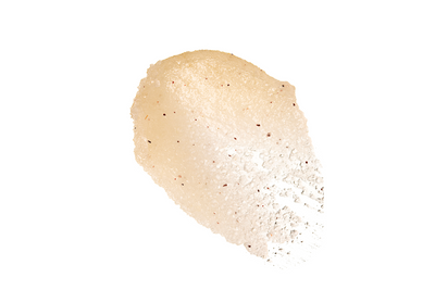 Close-up of Hair Addicct Renew Me Hair Balm's creamy, enriched texture smeared on a white background to highlight its moisturizing and restorative benefits.